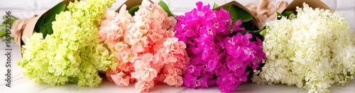 Four bouquets of colorful flowers in kraft paper