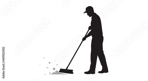 a person sweeping floor with broom creating dust clouds