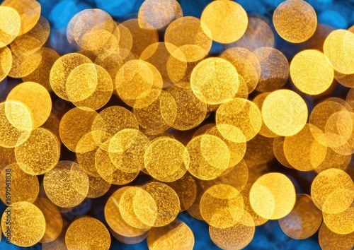 Abstract bokeh background of golden circles on a blue backdrop