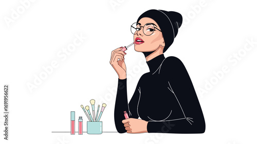 Stylish young muslim woman wearing a black hijab and glasses applying lipstick with a makeup brush looking confident and elegant