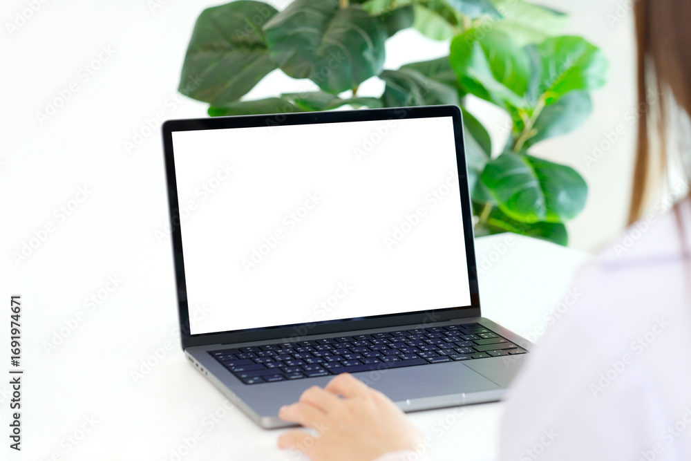 Fototapeta premium Laptop computer screen mockup, template background banner, Woman hand typing laptop computer with blank screen, Business online, e commerce, online study concept