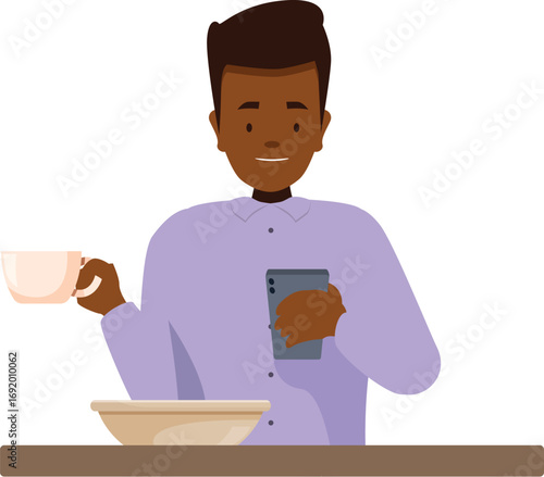 Smiling man using mobile phone and drinking coffee at breakfast table