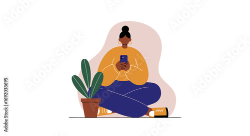 African American woman sits relaxed, engrossed in her smartphone. Ideal for themes of digital communication, social media, remote work, or connected lifestyle.