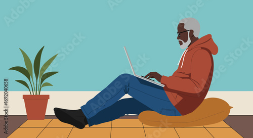 An older man comfortably works from home on his laptop, embodying remote work, digital lifestyle, and modern senior living.