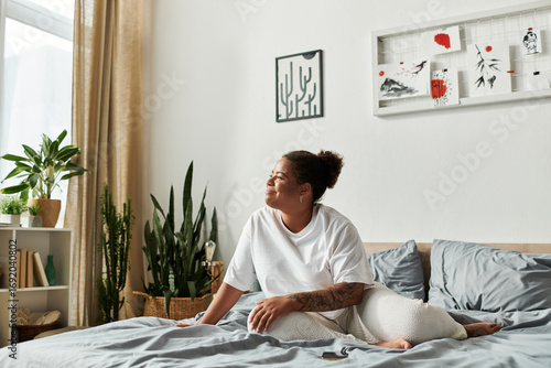 Quadro em tela Morning awakening of a woman in her modern bedroom filled with natural light