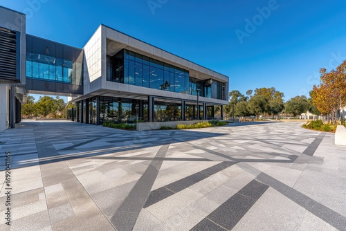 Modern office building exterior with patterned plaza.