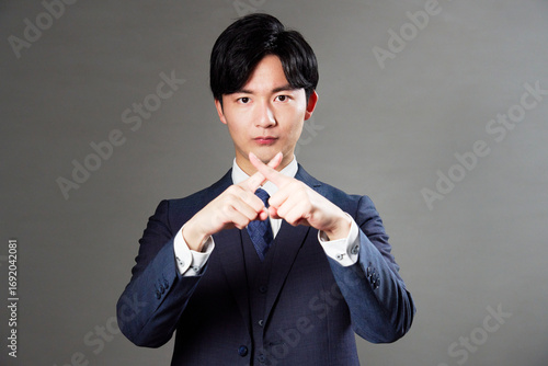 Wallpaper Mural ビジネスマン　ばつ印のジェスチャー　黒背景 Torontodigital.ca