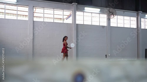 Female pickleball player running across court during training