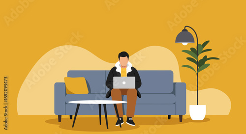 A man sits comfortably on a sofa, focused on his laptop, embodying modern remote work or online learning. Ideal for concepts of productivity, digital lifestyle, and home office.