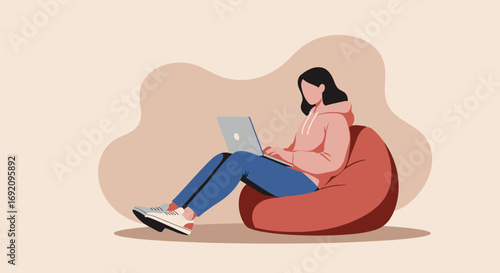 Young woman comfortably works or studies on a laptop from a bean bag chair at home, highlighting remote productivity and modern lifestyle.