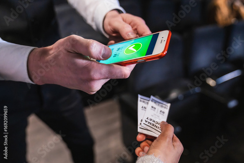 Fotografía Close up of usher scanning mobile ticket on smartphone, verifying access for mov