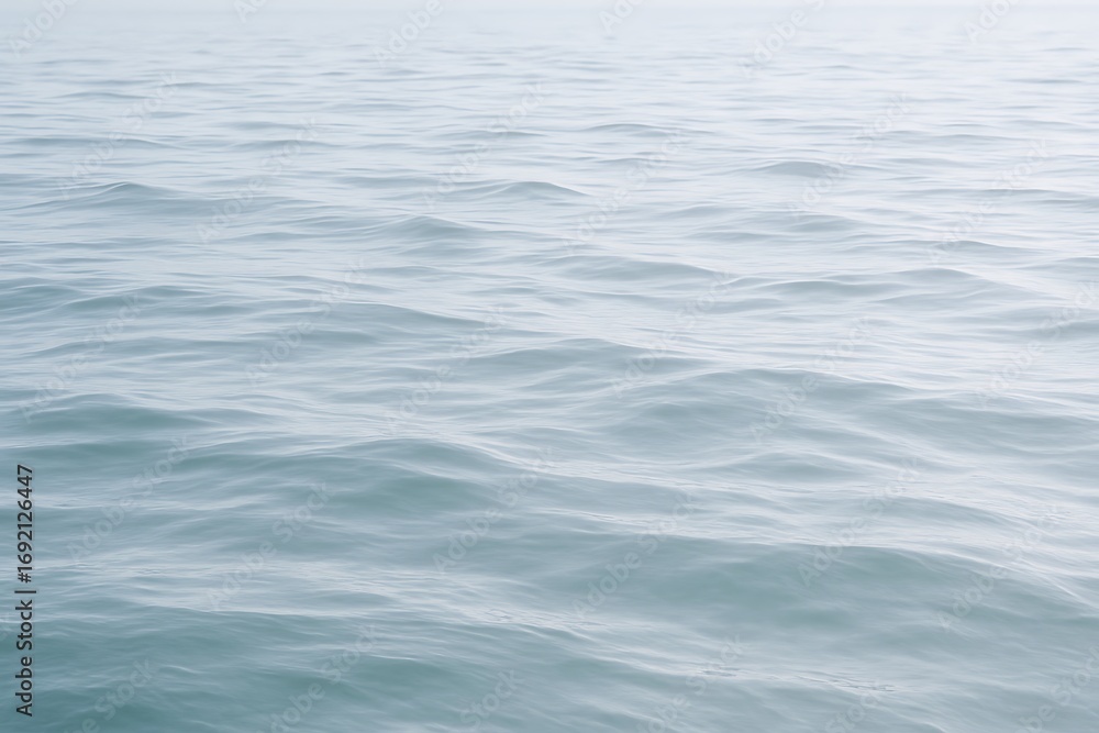 Fototapeta premium Calm ocean surface reflecting soft light during early morning hours