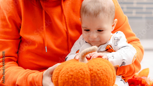 Baby with a pumpkin in Halloween themed photo shoot