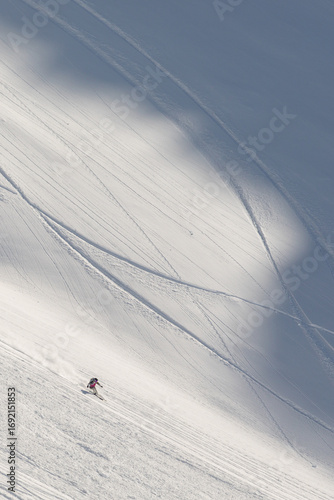 A skier swiftly descends a pristine slope in the breathtaking Pyrenees