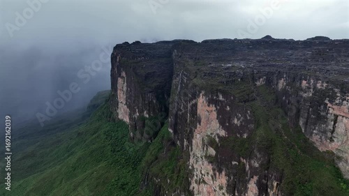 Aerial view of the majestic Roraima Mountain, its steep cliffs contrasting against the lush greenery, a stunning landscape, Paraitepui, Canaima, Venezuela.