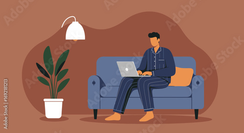 Man in pajamas comfortably working on a laptop from his home couch, highlighting remote work, online learning, or leisure.