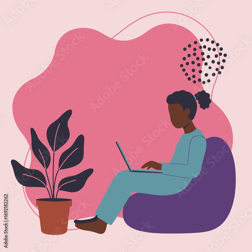 Person comfortably uses laptop on a bean bag chair at home, reflecting remote work, online learning, or digital tasks.