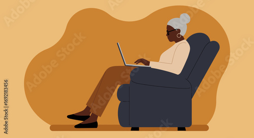 Elderly Black woman focused on her laptop from the comfort of a chair. Captures remote work, lifelong learning, and a modern, digitally connected senior lifestyle.