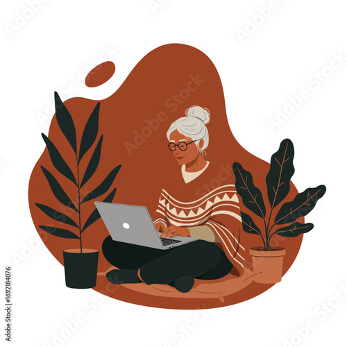 Elderly woman uses laptop while sitting comfortably at home with plants. Represents modern seniors, online learning, or remote work lifestyle.