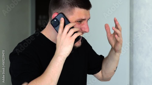 Angry European man talking on the phone and angry at someone.
Man angry and shouting on the phone.
Conflict situation and unpleasant conversation.
Conflict, problem, shouting, man