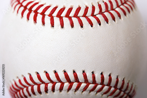 Close-up of white baseball stitched with red thread
