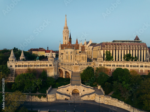 Aerial view of the enchanting Fisherman's Bastion with its fairytale towers and the majestic Matthias Church casting shadows across the Danube, Budapest, Budapest, Hungary.