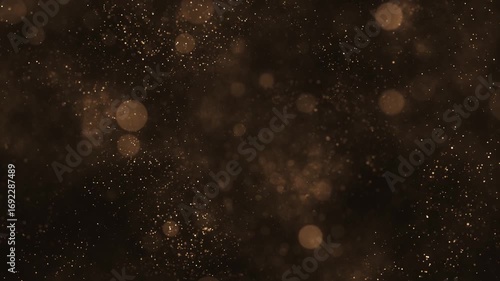 Luxury background with glittering shiny gold particles and shimmering bokeh light spheres. Elegant golden background ideal for glamorous events, award ceremonies or talent shows. 