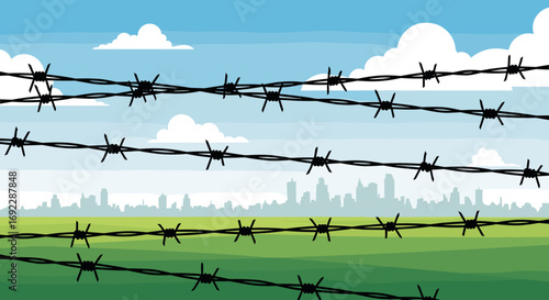 Barbed wire fences stretching across a green field with a city skyline in the background