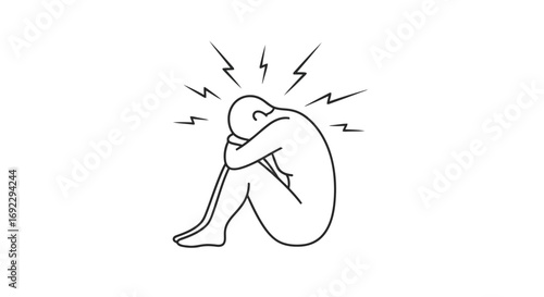 Person sitting with head in knees, feeling stressed