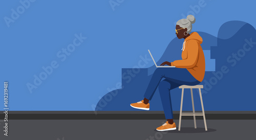 Mature African American woman with gray hair actively uses a laptop, representing digital literacy, online learning, or remote work for seniors. Modern lifestyle.