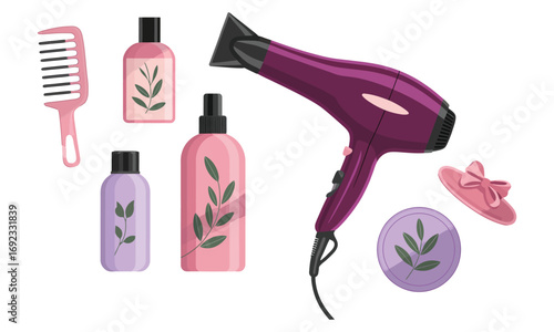 Flat lay of hair care and styling products including dryer, comb, bottles, clip, and container with leaf motifs on white background