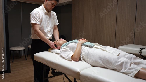 Asian woman enjoying relaxing oil massage at spa wellness center