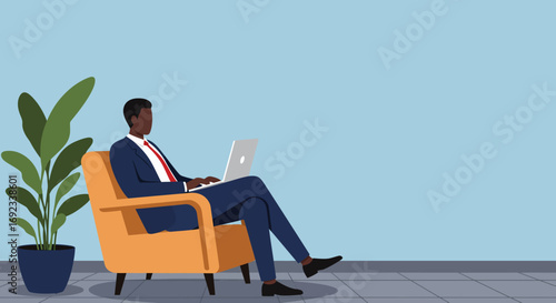 Professional Black businessman working remotely on a laptop, comfortably seated in a modern office lounge. Ideal for concepts of productivity, freelance work, or digital business.