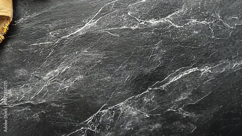 Intricate Black Marble Surface with Fabric Detail Backgrounds and textures