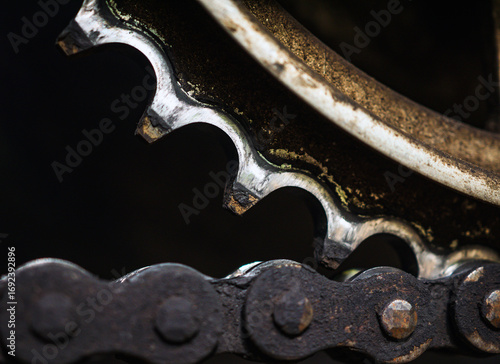 Motorcycle chain is attached to rear sprocket, Close up of dirty used motorbike chain. Rust motorcycle chain needs to be cleaned and greased