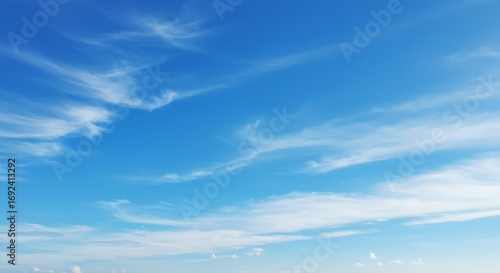 Blue sky with wispy clouds.