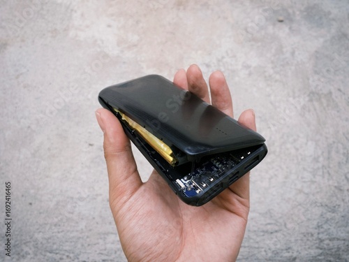 Damaged exploded powerbank smartphone charger due to battery swelling