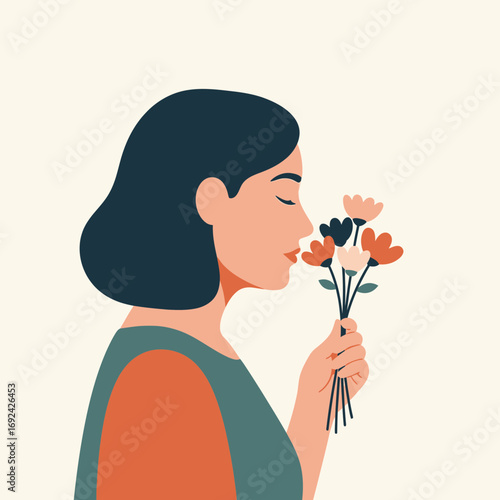 Woman smelling a bouquet of flowers with eyes closed.