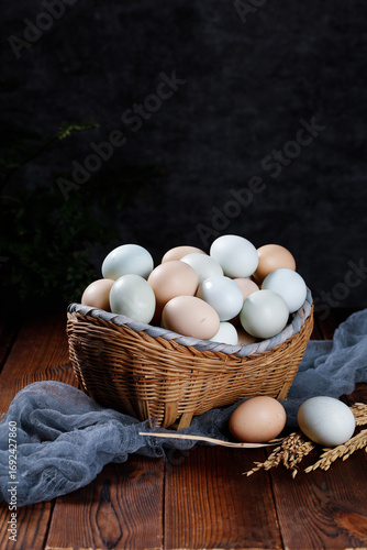 Fresh Farm Eggs in Rustic Wicker Basket on Wooden Table with Natural Wheat Decoration