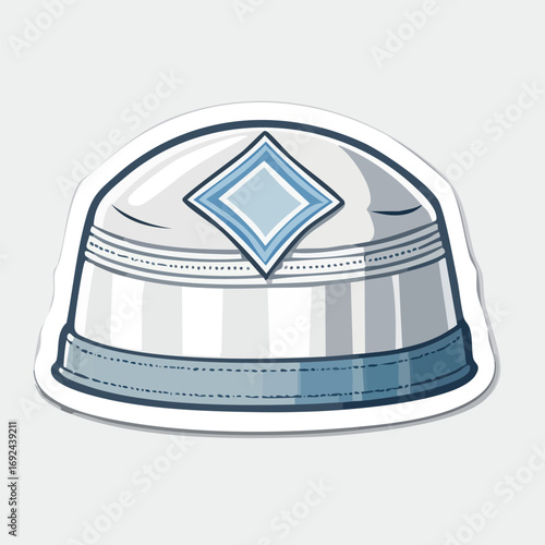 A sticker of a white and blue kufi hat with a diamond-shaped design on top.