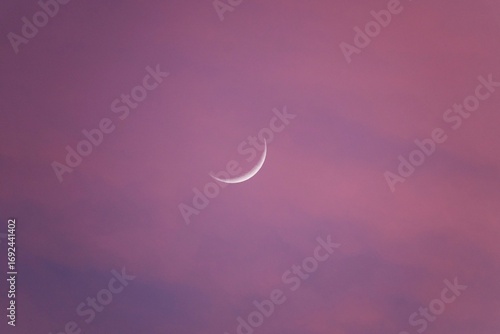 The first crescent moon, also known as the initial crescent moon, a small sliver of light in the west at sunset, shaped like an upside-down “C,” which becomes the first quarter moon isolated
