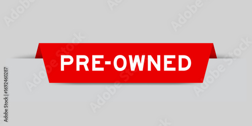 Red color inserted label with word pre-owned on gray background