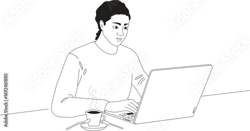 A handsome young man in casual clothes is smiling while working on his laptop