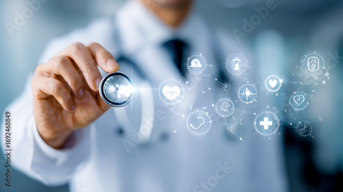 A doctor holding up their stethoscope with digital health symbols floating around them
