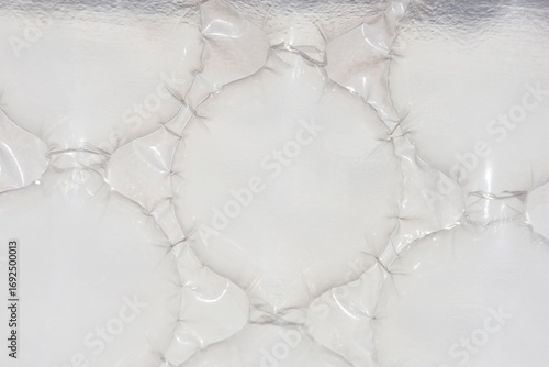 A close-up, abstract shot shows a pattern of connected, light-grey plastic bubbles used for transport