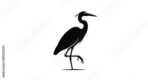 Elegant black silhouette of a heron standing on one leg against a white background