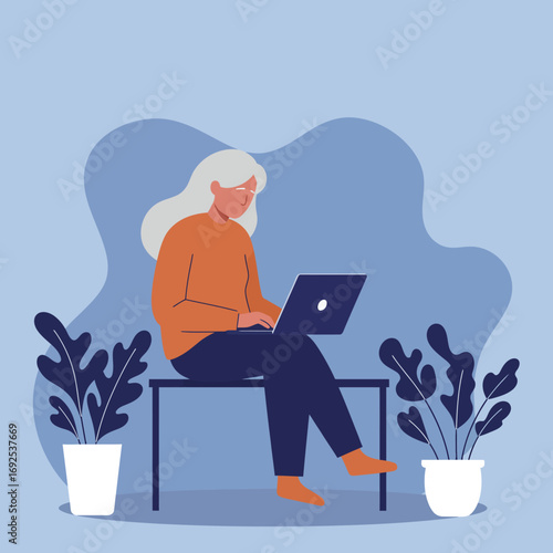 Mature woman working remotely on laptop at home, surrounded by plants. Represents online learning, freelance, or a connected modern lifestyle.
