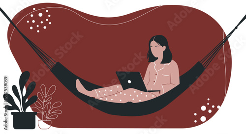A relaxed woman in pajamas works on her laptop while comfortably lying in a hammock at home. Depicts remote work, leisure, and a flexible lifestyle.
