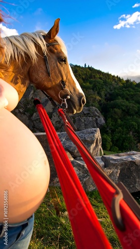 Pregnant woman with horse at scenic overlook