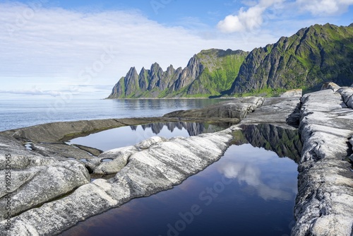 Reflection in a tidal pool, rocky coast of Tungeneset, Devil's Teeth, Okshornan, Ersfjorden, Senja Island, Troms, Norway